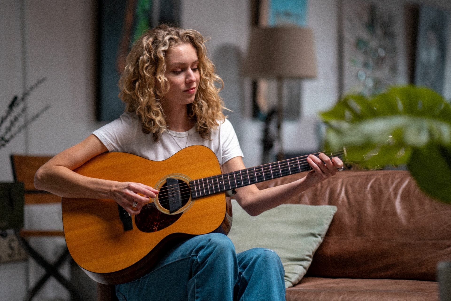 woman playing guitar when bored