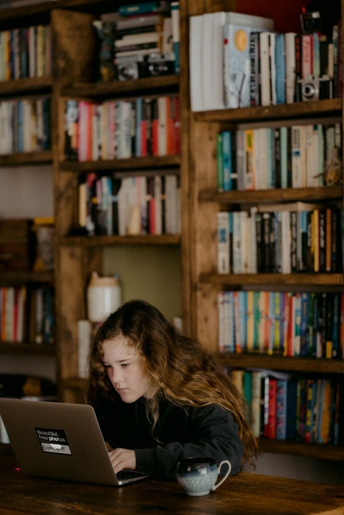 woman doing homework in library