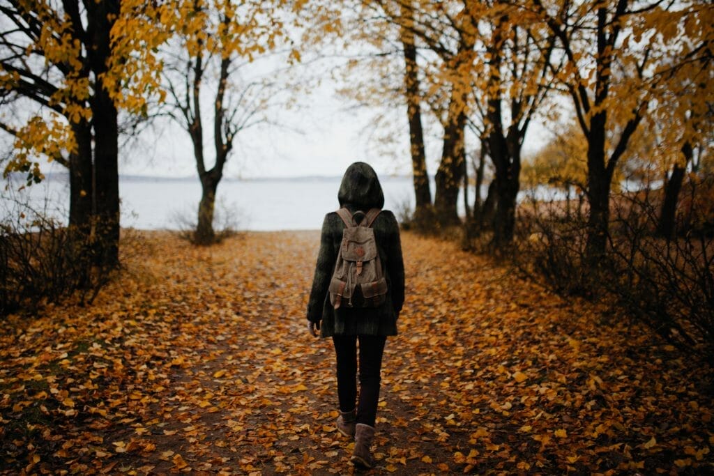 woman-going-for-a-walk-in-leaves