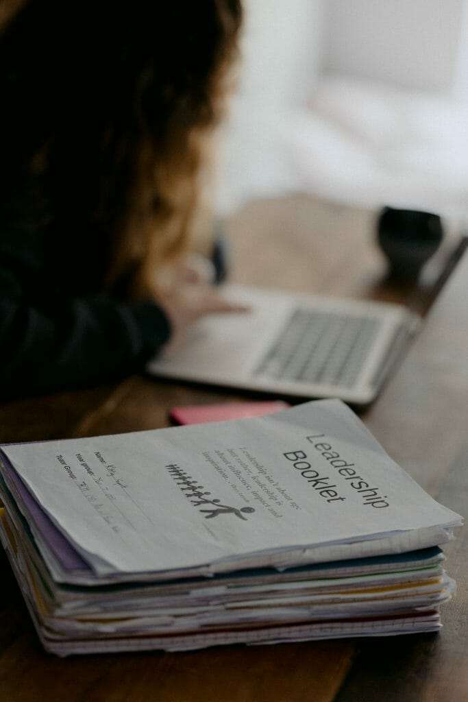 girl doing homework on laptop