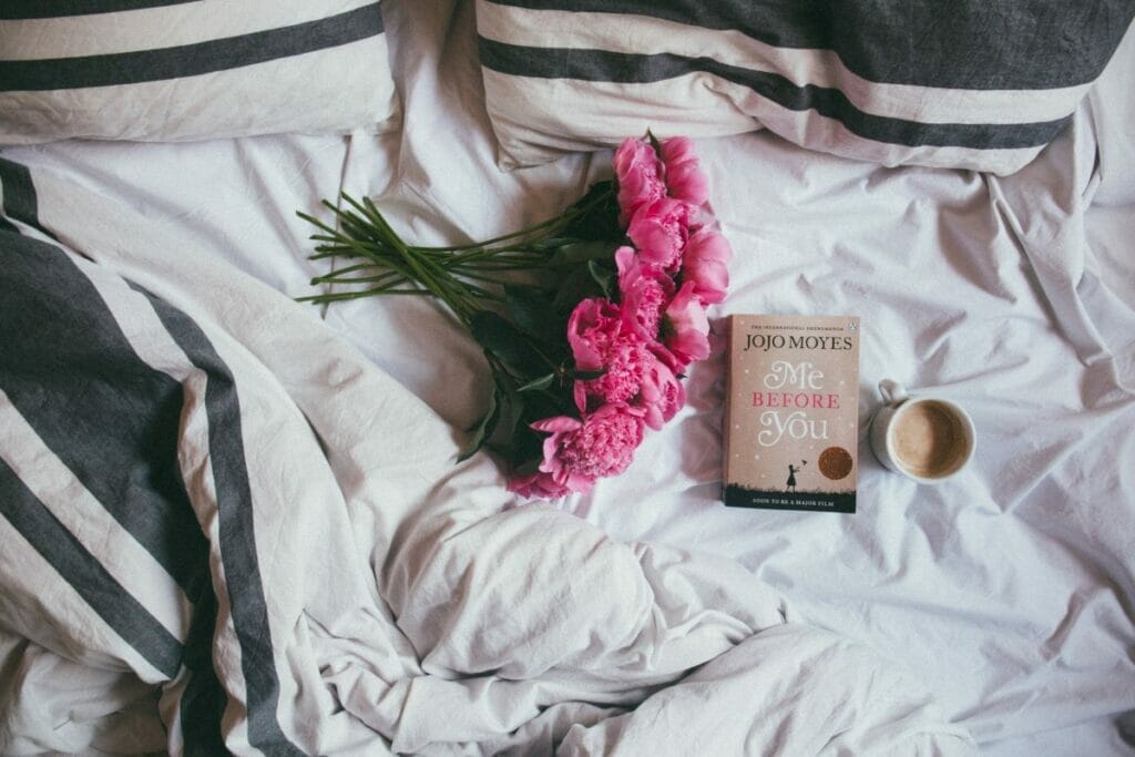 flowers and book on a bed