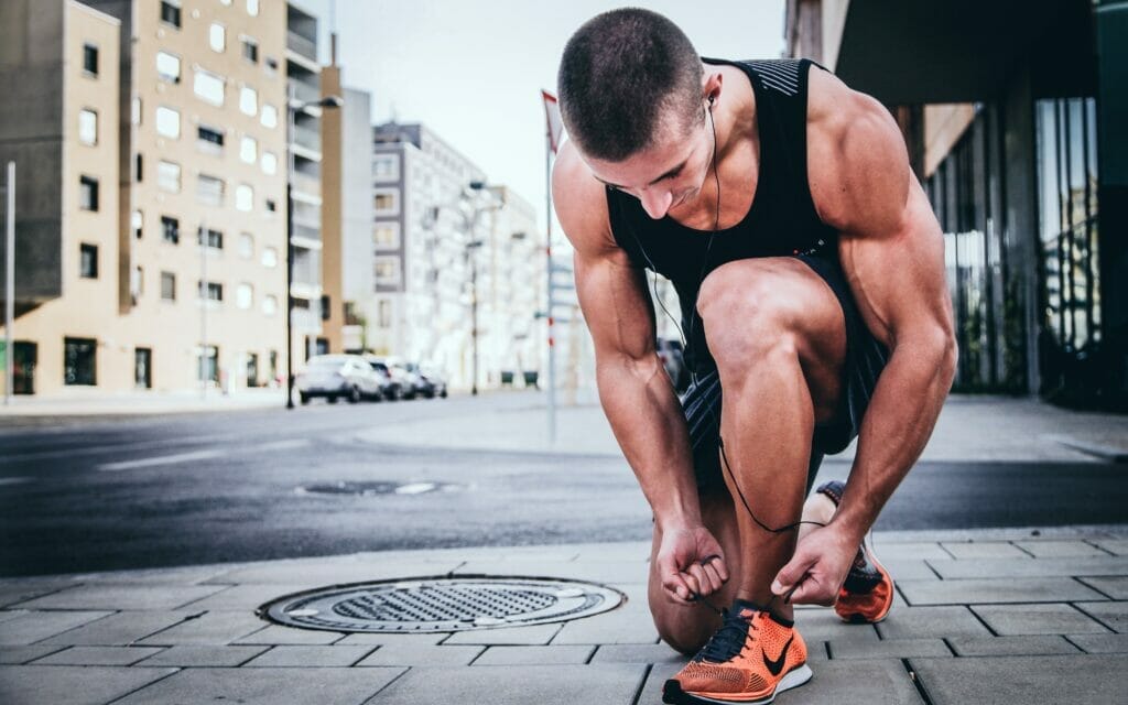 man tying shoes