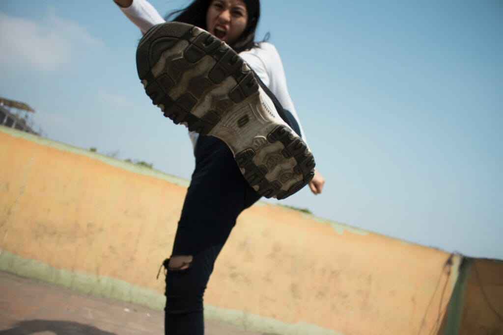 girl kicking her foot at the camera