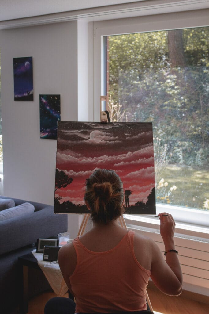 woman painting a sunset