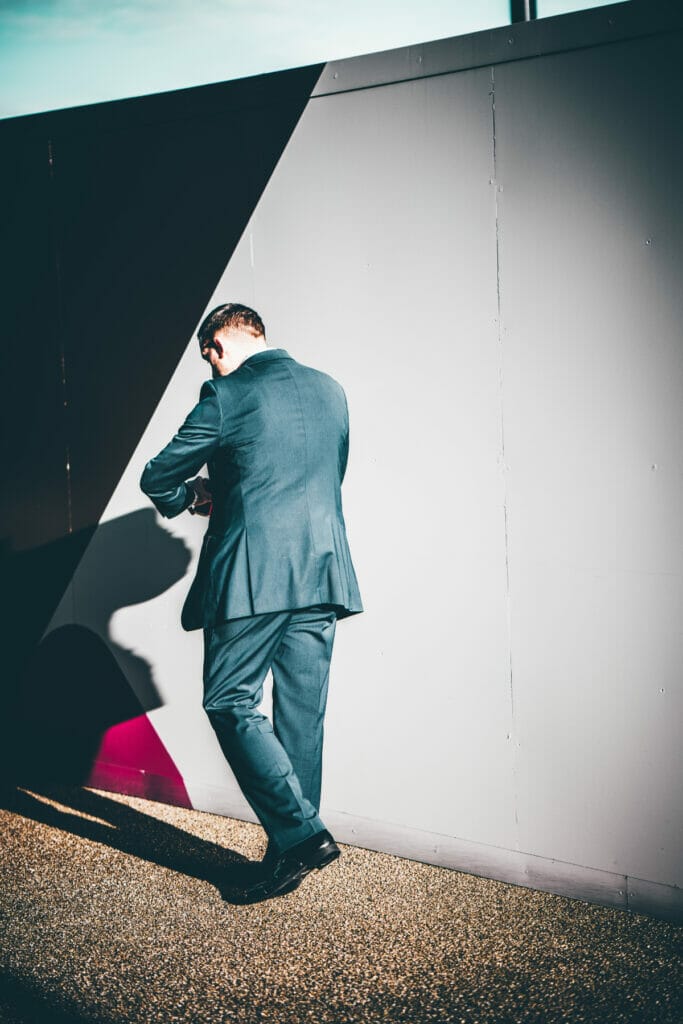 man in suit looking at watch