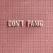 pink-board-that-says-don't-panic